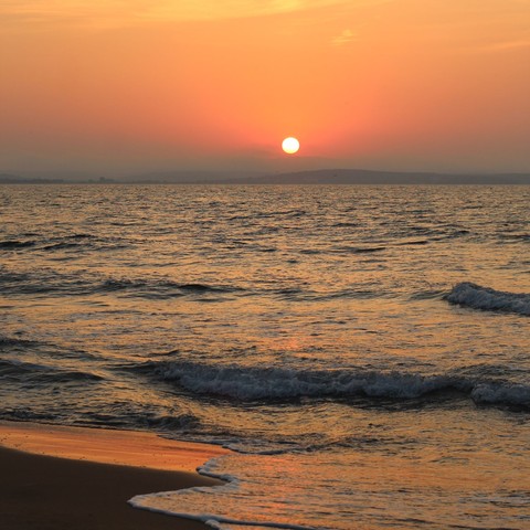Ocean waves along the coast at sunset
