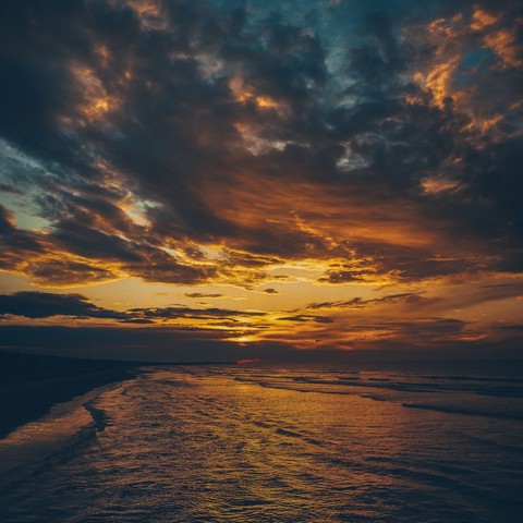 A golden sunset over the sea and beach